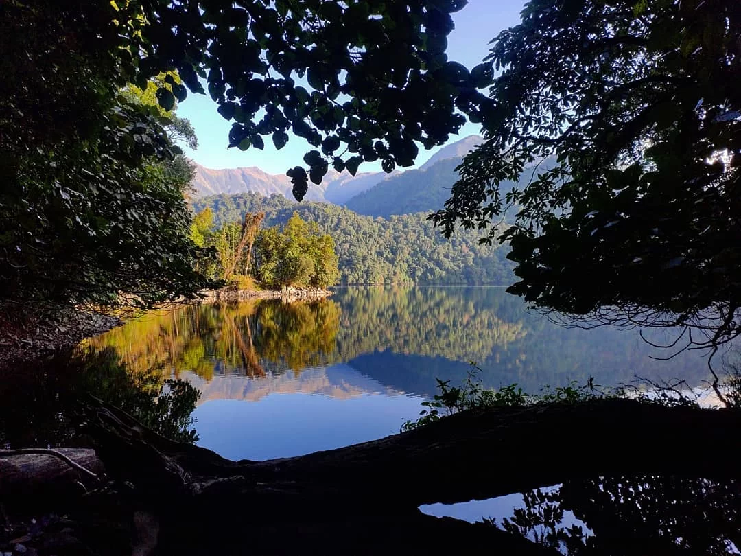 Mehao Lake tranquil freshwater lake surrounded by dense forests and scenic mountain reflections in Arunachal Pradesh Package.