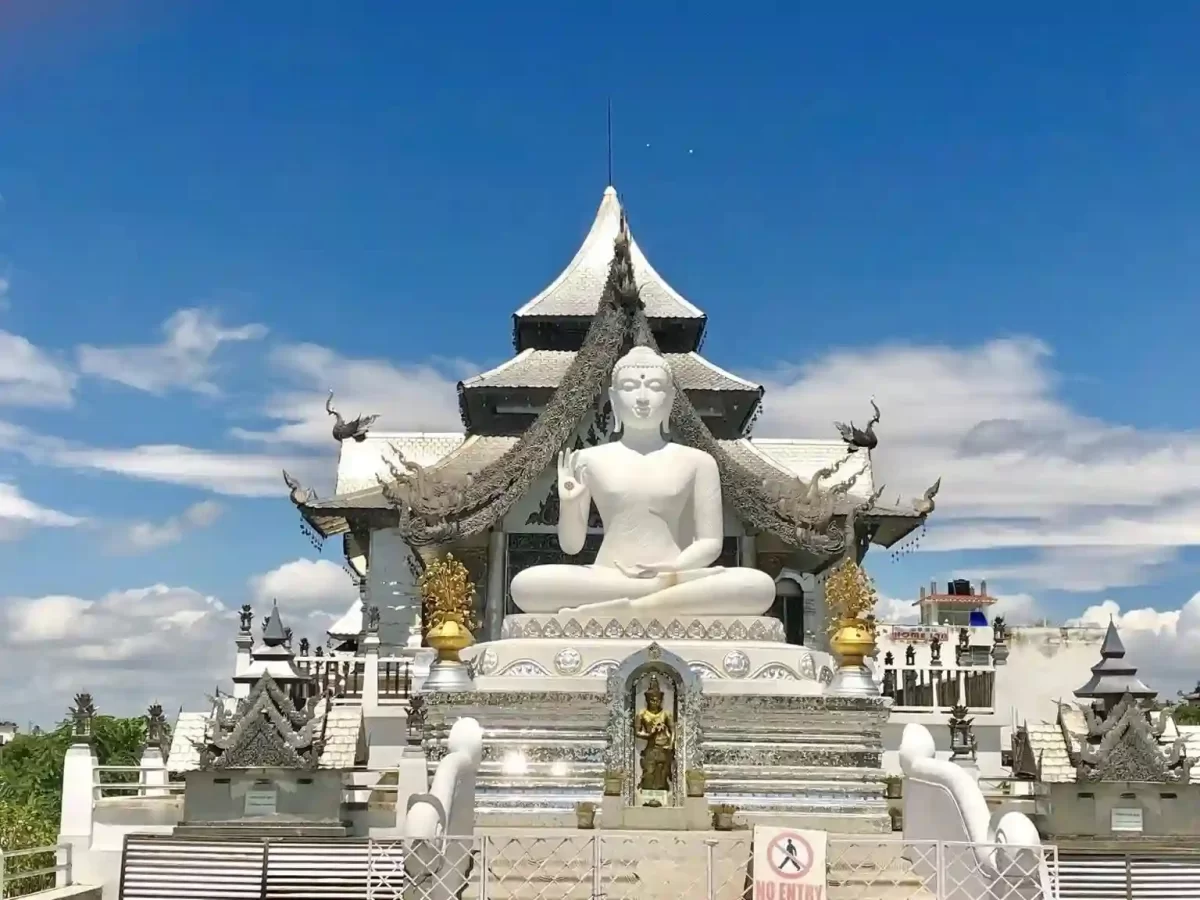 Metta Buddharam Temple Kushinagar, serene Buddhist temple featuring grand white Buddha statue and ornate Thai-style architecture in Uttar Pradesh.