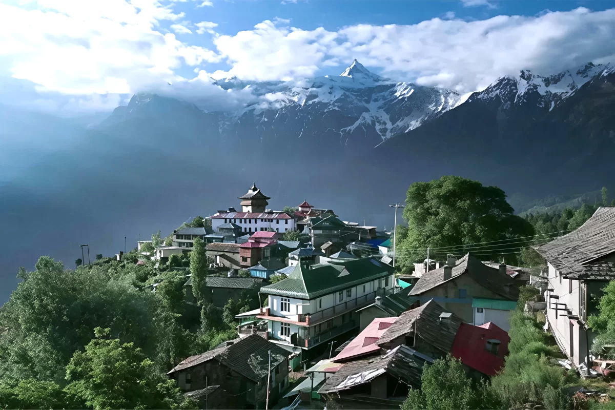 Hu-Bu-Lan-Kar Monastery at Kalpa during partly cloudy skies, featuring colorful temples prayer flags snowy mountains trees, perfect spiritual experience Himachal tour package.