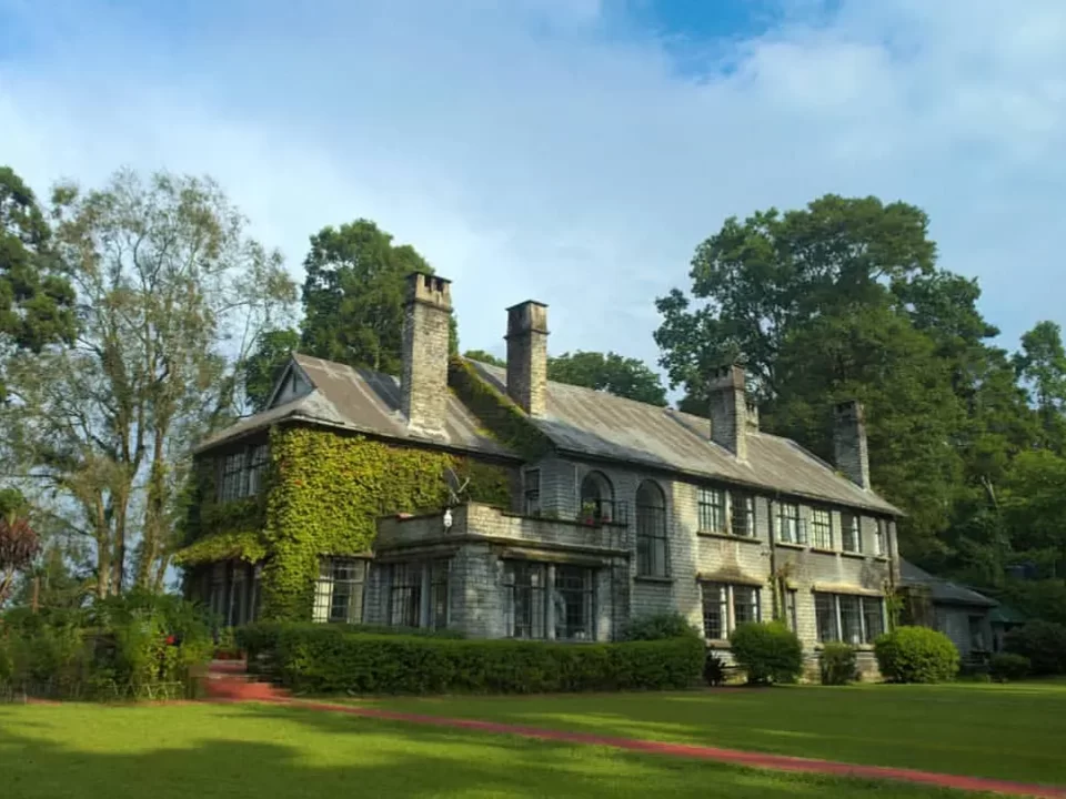 Morgan House heritage bungalow in Kalimpong, West Bengal, surrounded by manicured lawns and tall trees, a colonial-era property frequently featured in West Bengal tour packages.