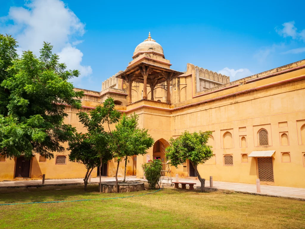 Government Museum Ajmer Rajasthan sandstone Mughal architecture Akbari Fort complex arched jharokhas dome minarets green lawns trees blue sky heritage courtyard Rajputana Museum historical landmark.