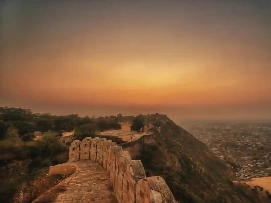 Nahargarh Sunset Point Jaipur Scenic hilltop viewpoint offering a panoramic orange sky over the Pink City Rajasthan.