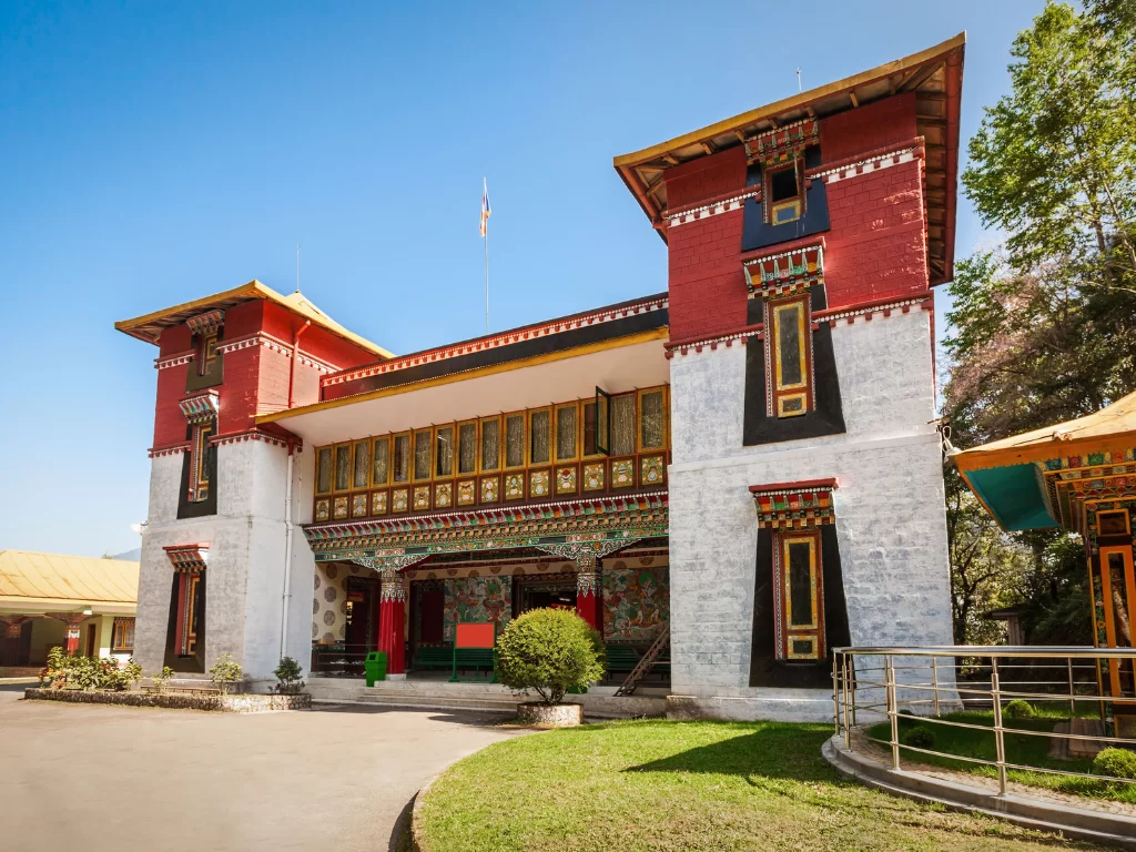 Namgyal Institute of Tibetology Gangtok during clear skies, featuring traditional Tibetan facade manicured lawns, perfect cultural heritage experience Sikkim tour package.