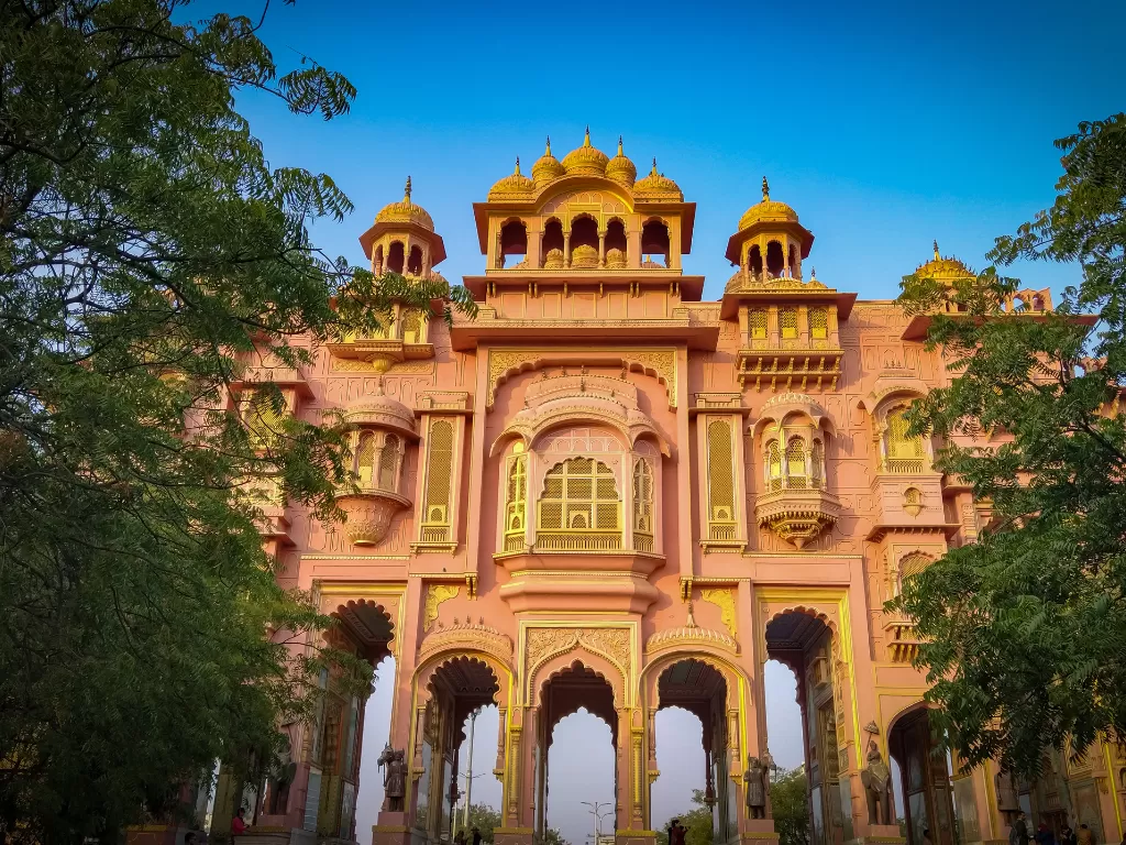 Patrika Gate Jaipur golden domes pink Rajasthani arches trees blue sky Jawahar Circle Park Rajasthan cultural heritage tour packages.
