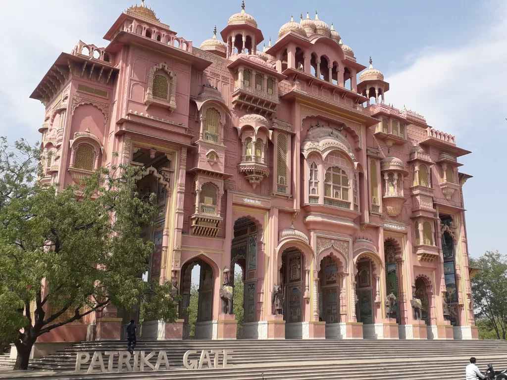 Patrika Gate Jaipur pink Rajasthani architecture domes arches elephants trees staircase signboard Jawahar Circle Garden Rajasthan tour packages.