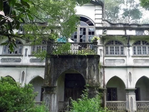 Pratima Tagore House in Kalimpong, West Bengal, showcasing colonial-era architecture with arched verandas and heritage detailing amid lush greenery, a historic landmark featured in West Bengal tour packages.