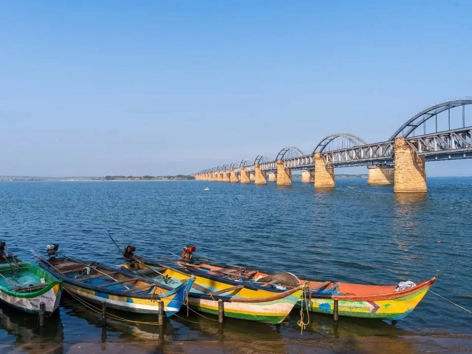 Pushkar Ghat, Rajahmundry riverside ghat with Godavari bridge and colorful fishing boats in Andhra Pradesh.