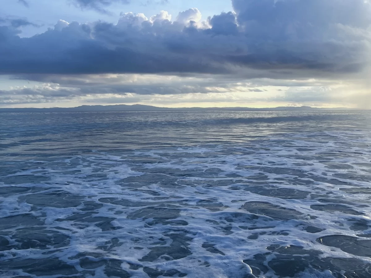 Radhanagar Beach Beach No.7 Havelock Island Andaman Nicobar sunset panorama during cloudy sky, featuring turquoise ocean waves, distant islands, perfect tropical beach tour package.