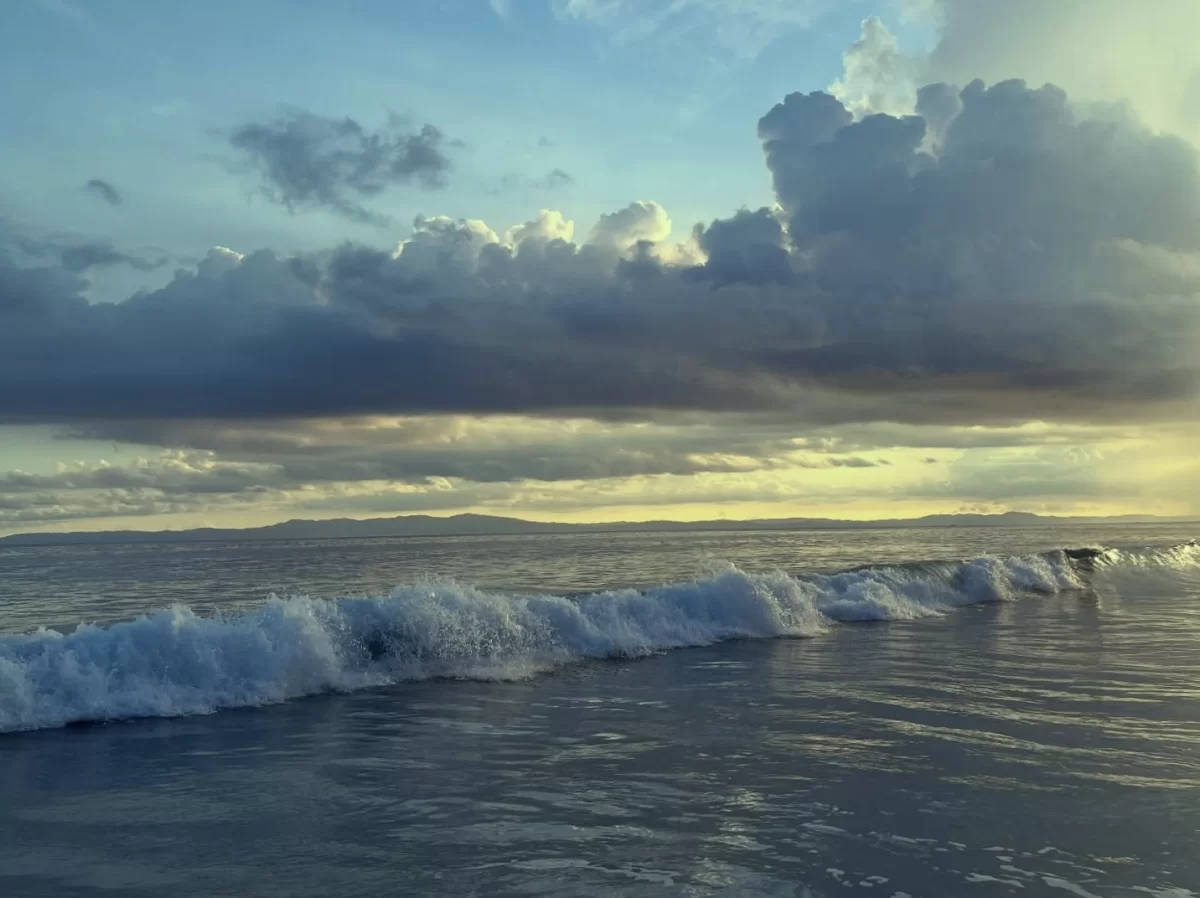 Radhanagar Beach Beach No.7 Havelock Island Andaman Nicobar golden hour with dramatic clouds, featuring turquoise ocean waves, distant islands, perfect tropical sunset tour package. 