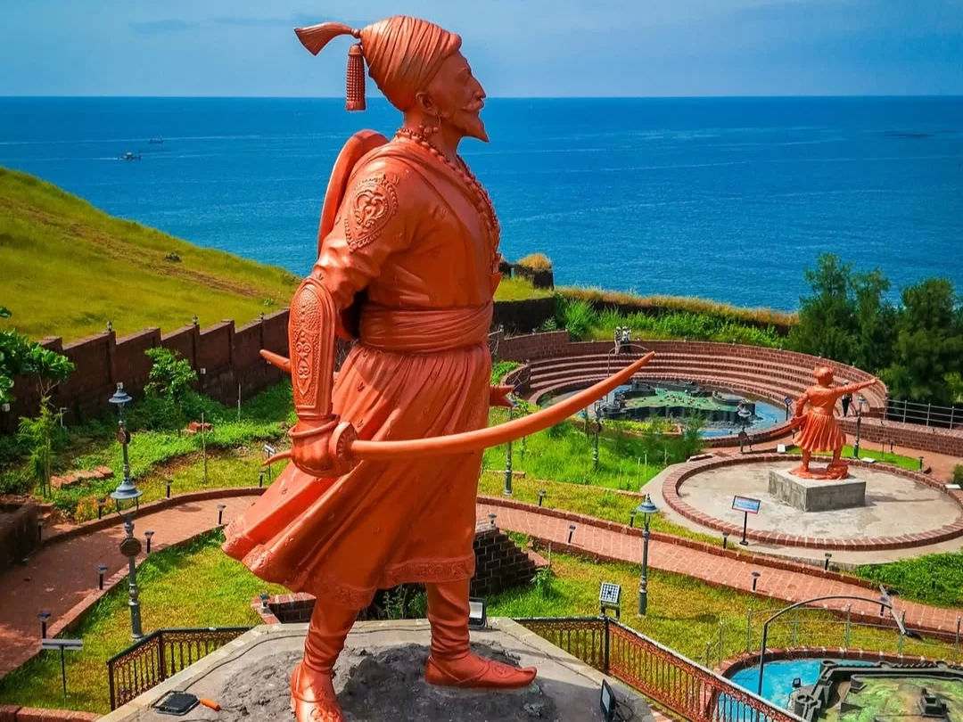Statue overlooking the Arabian Sea at Ratna Durga Fort in Ratnagiri, Maharashtra, surrounded by coastal views and historic fort walls, a prominent attraction included in Maharashtra tour packages.
