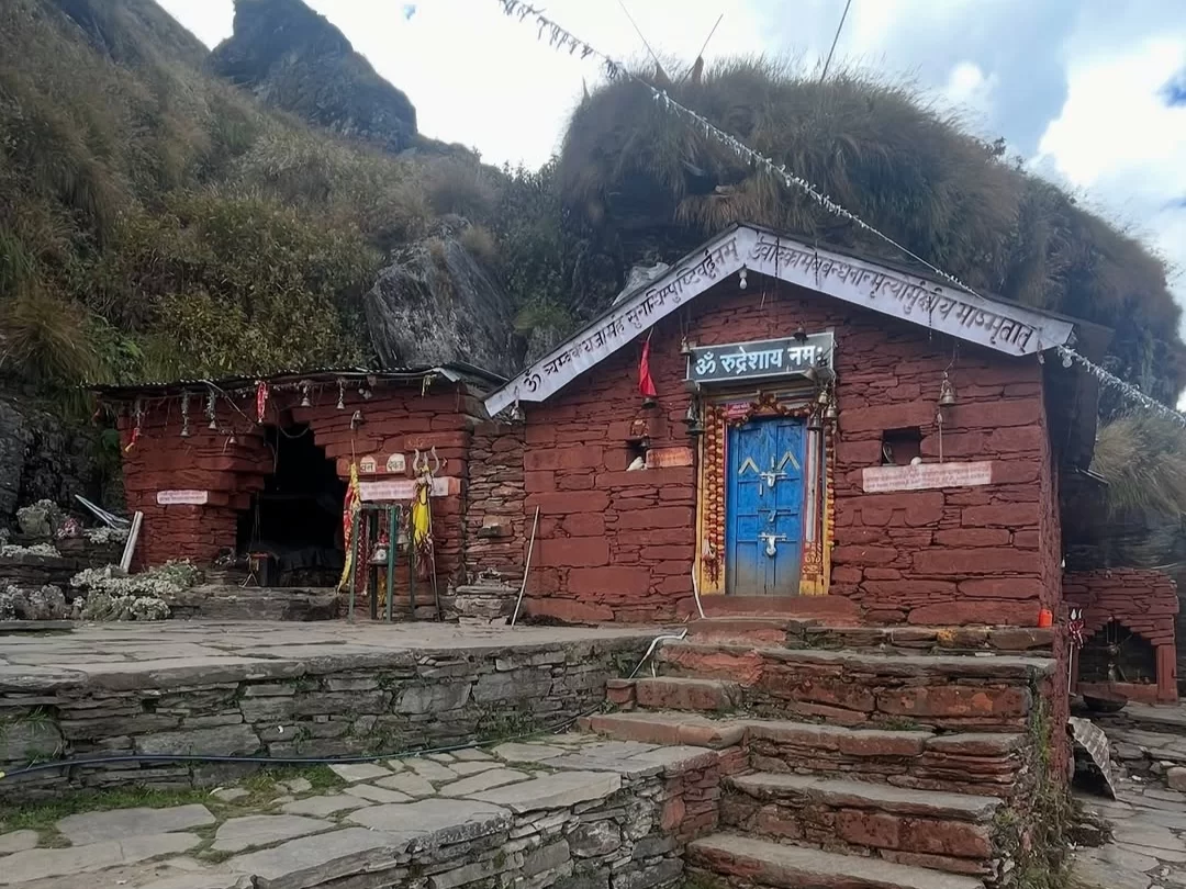 Rudranath Temple in Uttarakhand surrounded by scenic Himalayan mountains, sacred pilgrimage site and spiritual trekking destination included in Uttarakhand tour packages