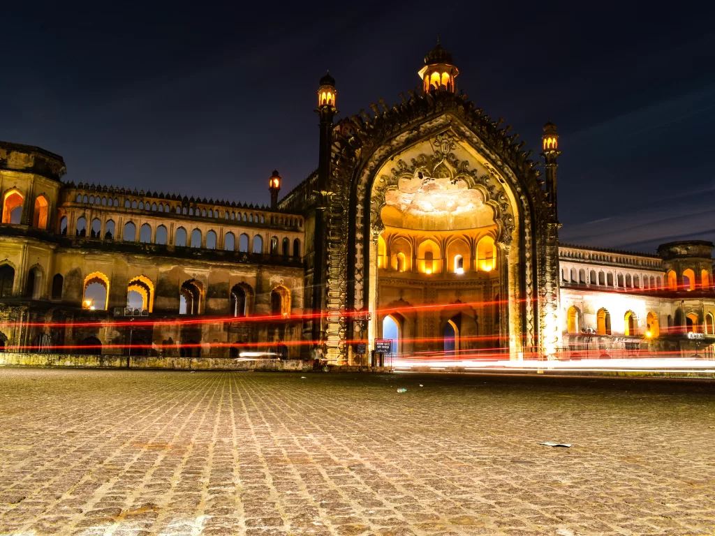 Rumi Darwaza illuminated at night in Lucknow, featuring light trails arches towers buildings, perfect romantic Uttar Pradesh tour package.