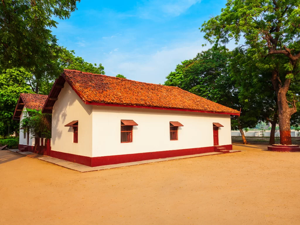 Mahatma Gandhi residence at Sabarmati Ashram Ahmedabad during daylight, featuring traditional architecture and trees, perfect cultural Gujarat tour package.