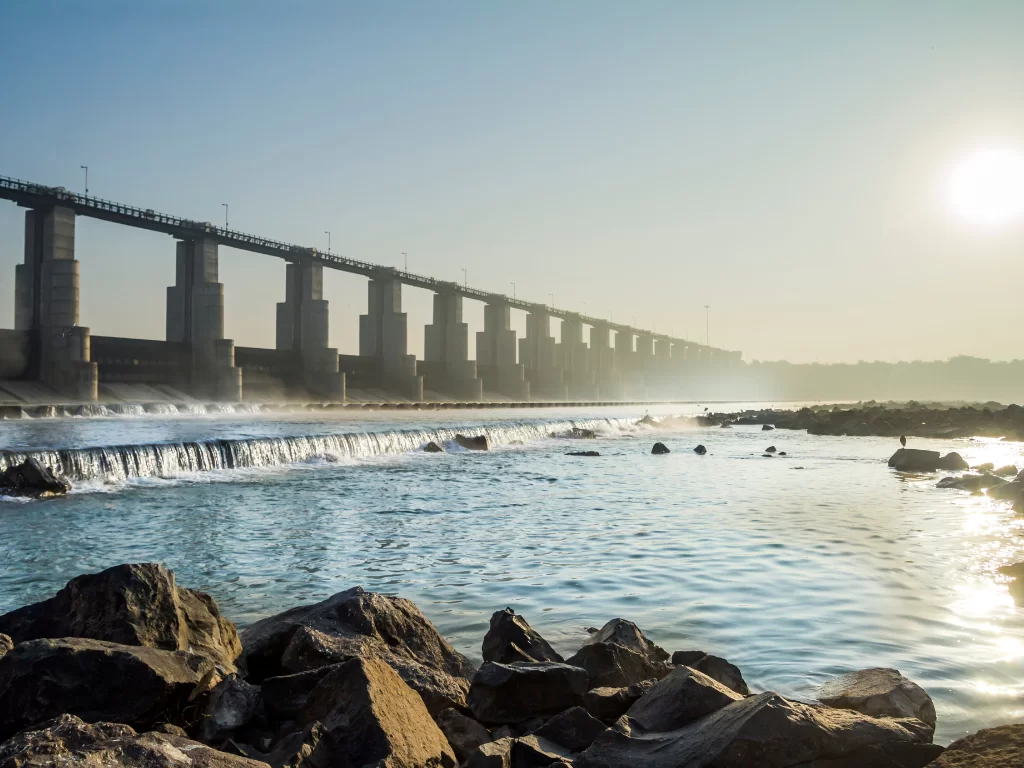 Sant Sarovar Dam at Gandhinagar during sunrise, featuring barrage structure, cascading water, reservoir reflections, perfect picnic experience with Gujarat tour packages.