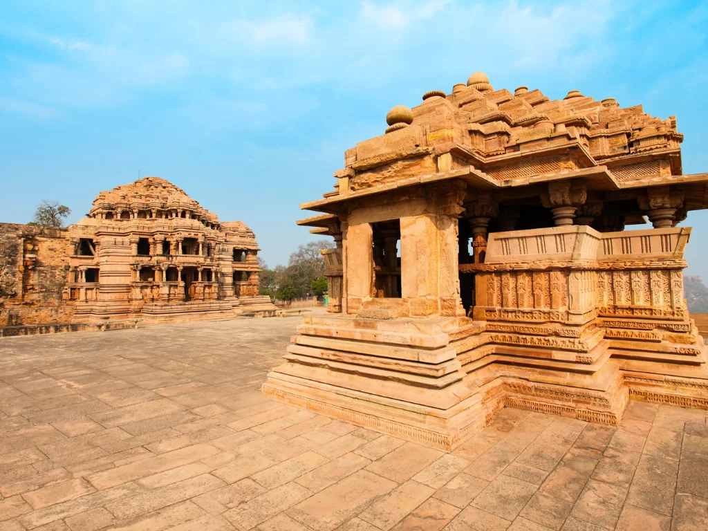 Sasbahu twin temples at Gwalior Fort under clear skies, featuring intricate carvings and elevated shrines, perfect heritage experience with Madhya Pradesh tour packages.
