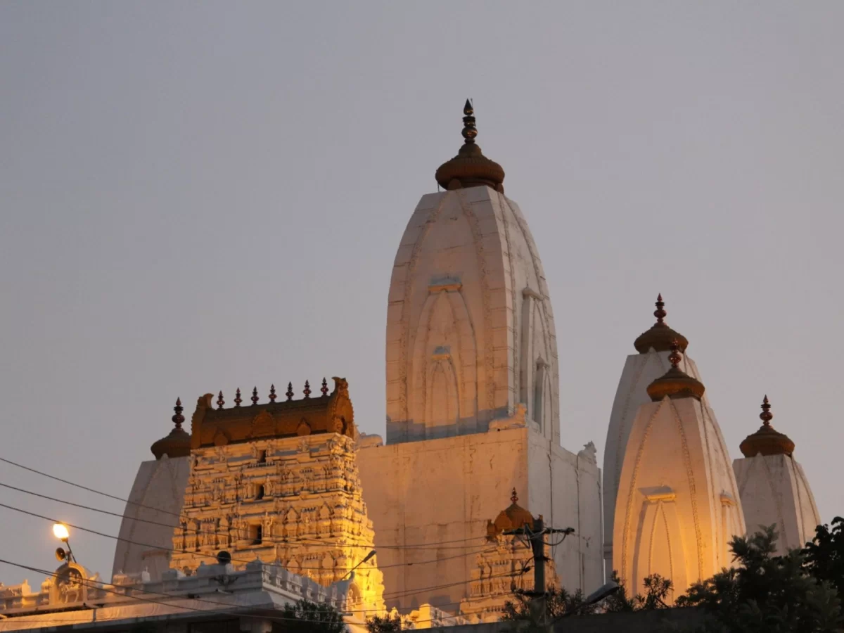 Shri Omkareshwara Swamy Temple at Madikeri Coorg during golden sunset, featuring white shikharas and dome architecture, perfect spiritual Coorg tour package.