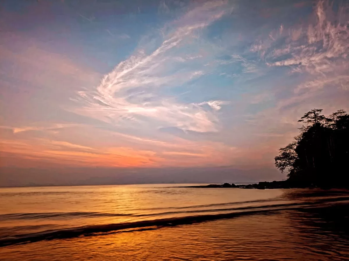 Sunrise at Sitapur Beach in Neil Island, featuring golden waves and pastel sky, perfect romantic Andaman honeymoon tour package