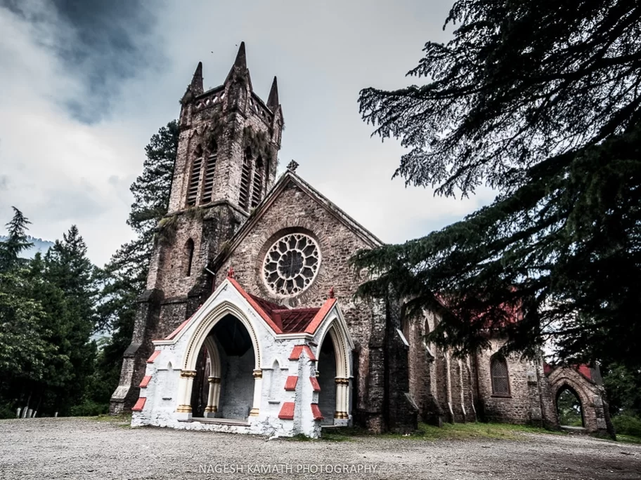 St John in the Wilderness C.N.I Church in Nainital, Uttarakhand featuring Gothic stone architecture amidst tall deodar trees, a historic colonial landmark included in Uttarakhand tour packages