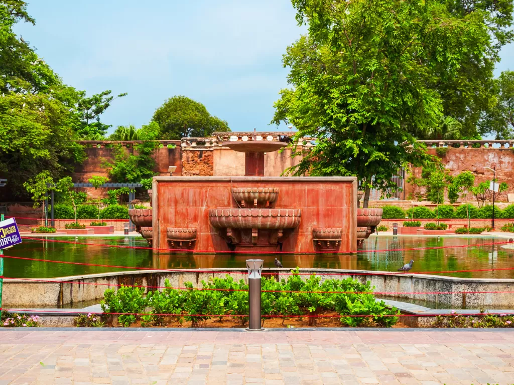 Fountain garden at Subhash Udyan in Ajmer during daytime, featuring red sandstone cascade and pond, perfect Ajmer sightseeing tour package