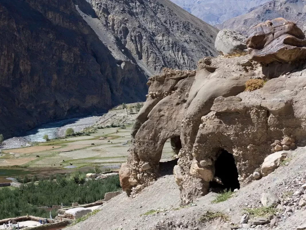 Tabo Caves natural arch at Tabo Spiti Valley during clear weather, featuring Spiti River green fields villages rugged mountains, perfect adventure experience Spiti Valley Himachal tour package.