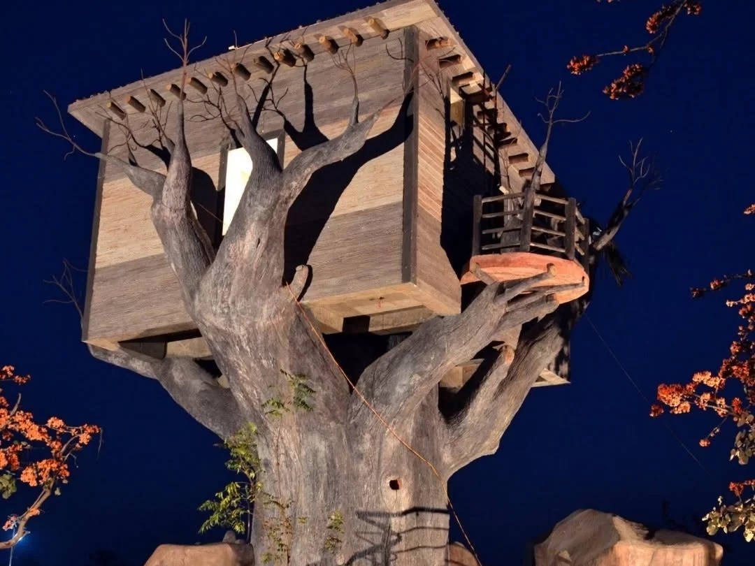 Tathastu Art Center in Madhya Pradesh featuring a unique treehouse-style structure illuminated at night, included in Madhya Pradesh tour packages