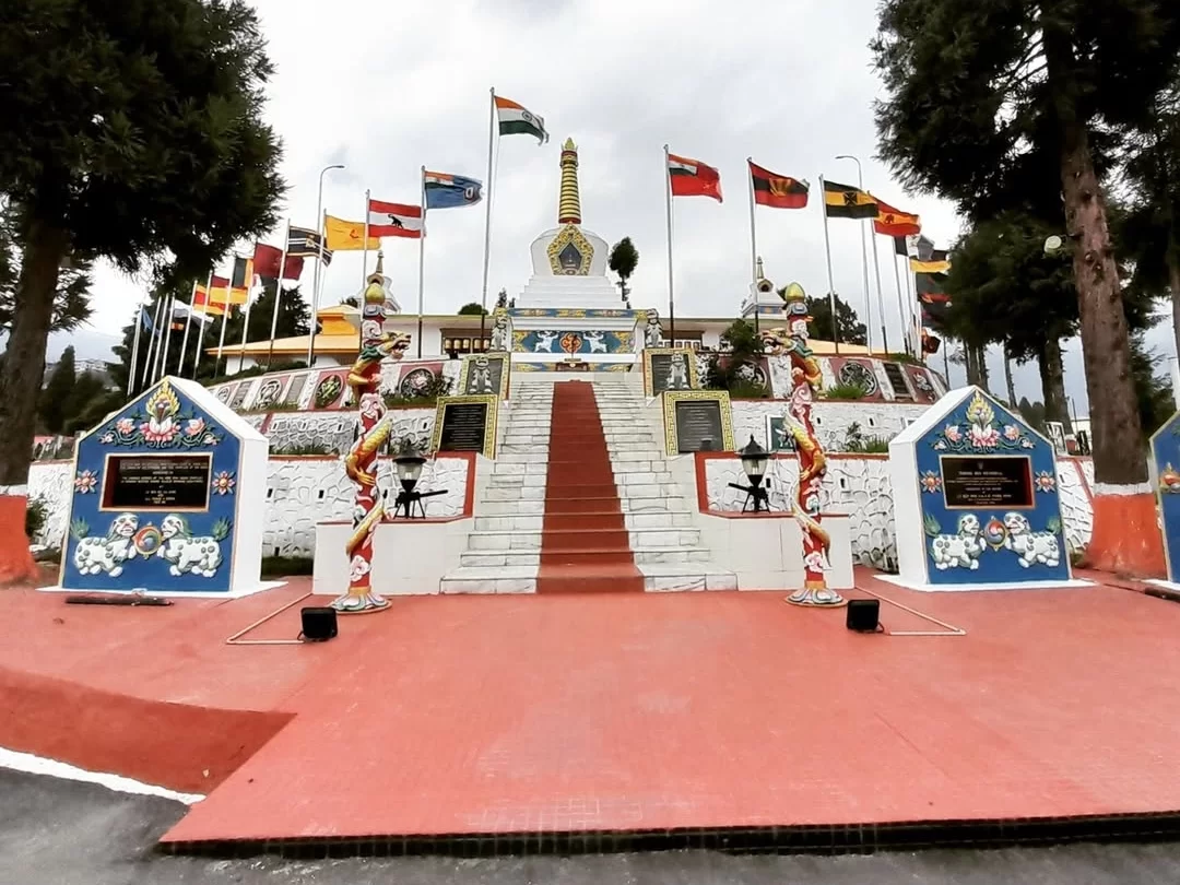 Tawang War Memorial majestic white stupa honoring brave soldiers amid scenic mountain surroundings in Arunachal Pradesh tour Package.