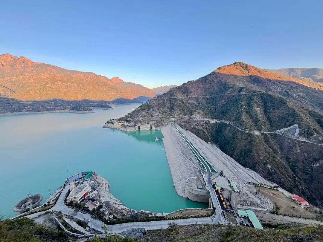 Tehri Dam in Tehri, Uttarakhand overlooking the vast turquoise reservoir and surrounding hills, a major engineering landmark featured in Uttarakhand tour packages