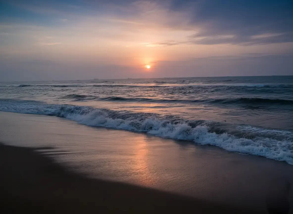 Thumba Beach peaceful sandy shoreline and the iconic red-and-white St. Mary Magdalene Church situated at the historic rocket launch site in Thiruvananthapuram.
