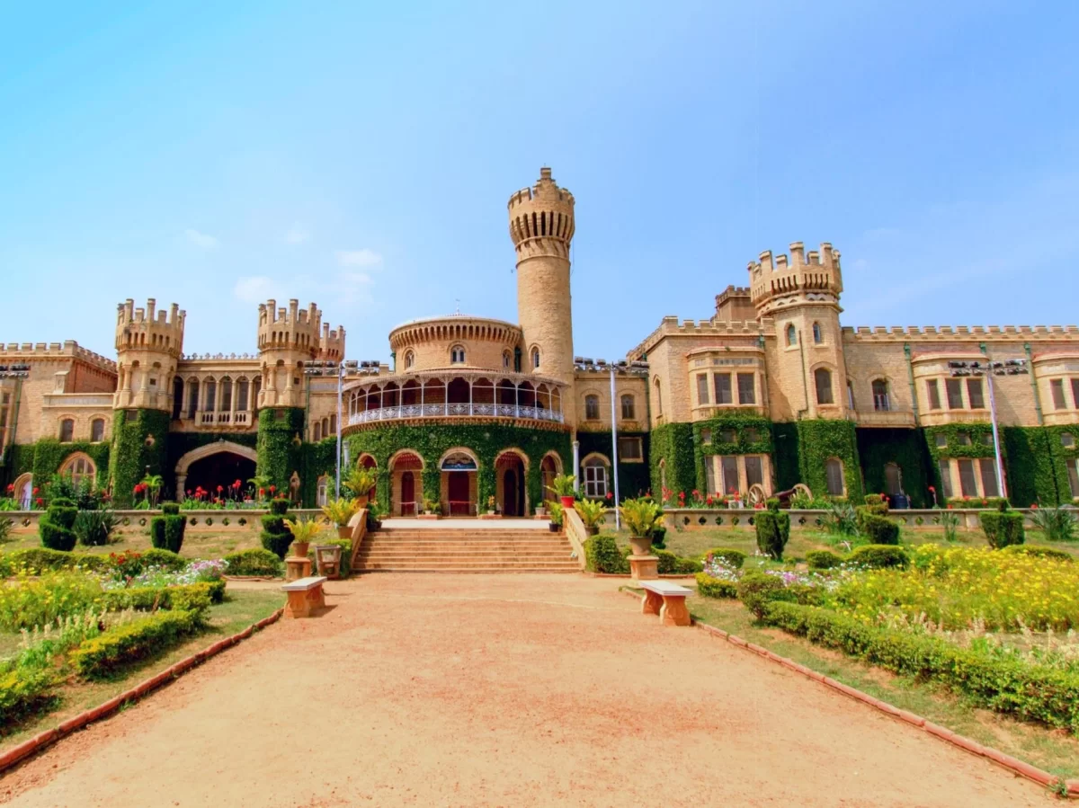 Tipu Sultan's Summer Palace Bangalore frontal view during sunny day, featuring Indo-Islamic architecture with towers and gardens, perfect Karnataka heritage tour package.