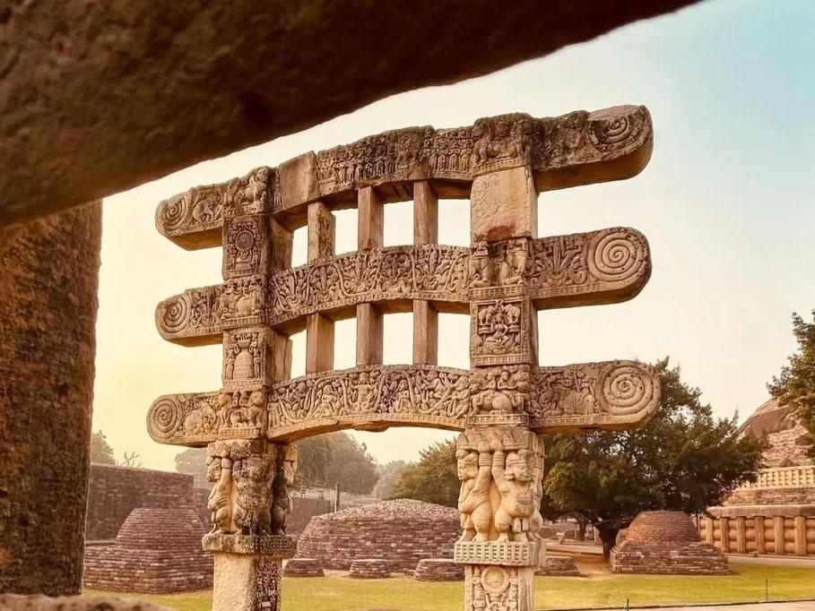 Carved stone toranas at Sanchi Stupa in Sanchi, Madhya Pradesh showcasing intricate Buddhist reliefs, featured in Madhya Pradesh tour packages