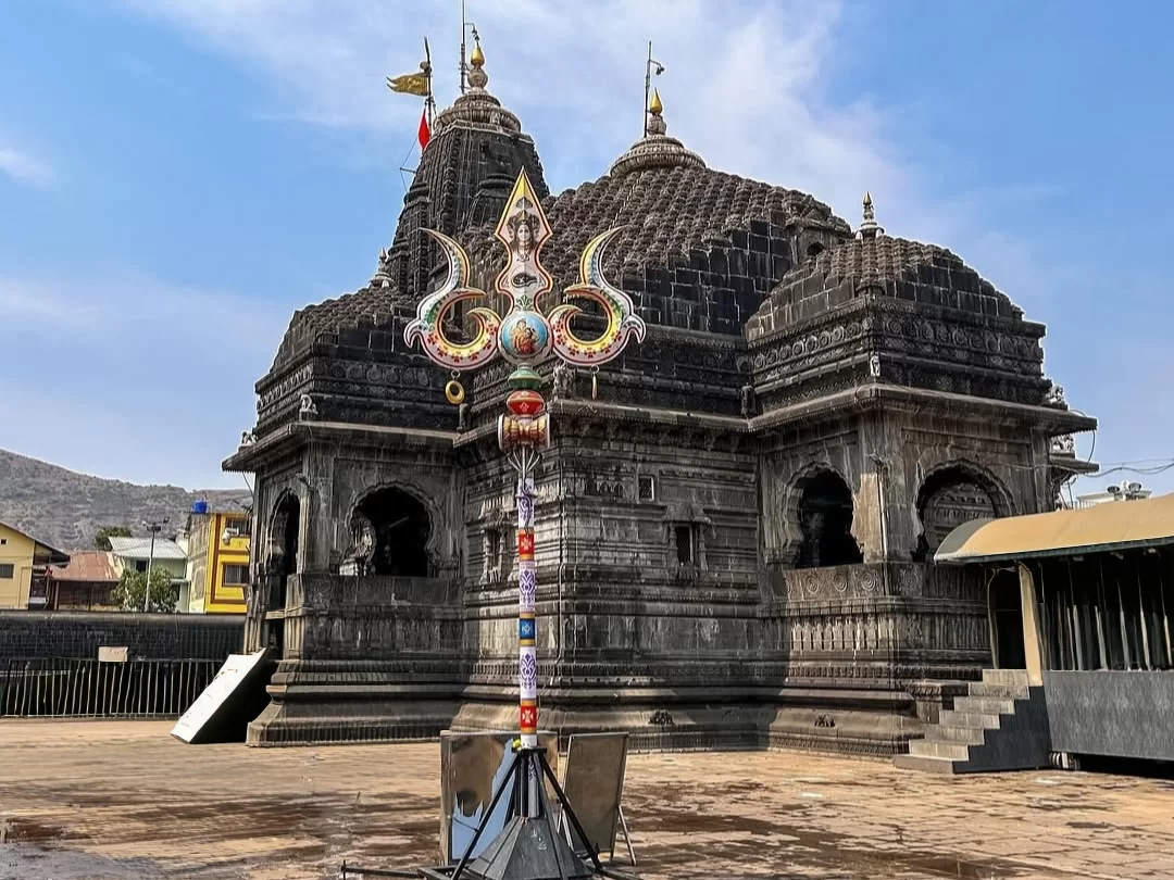 Trimbakeshwar Jyotirlinga Mandir in Maharashtra built in black stone with detailed temple architecture and sacred Trishul in the courtyard, an important pilgrimage destination featured in Maharashtra tour packages