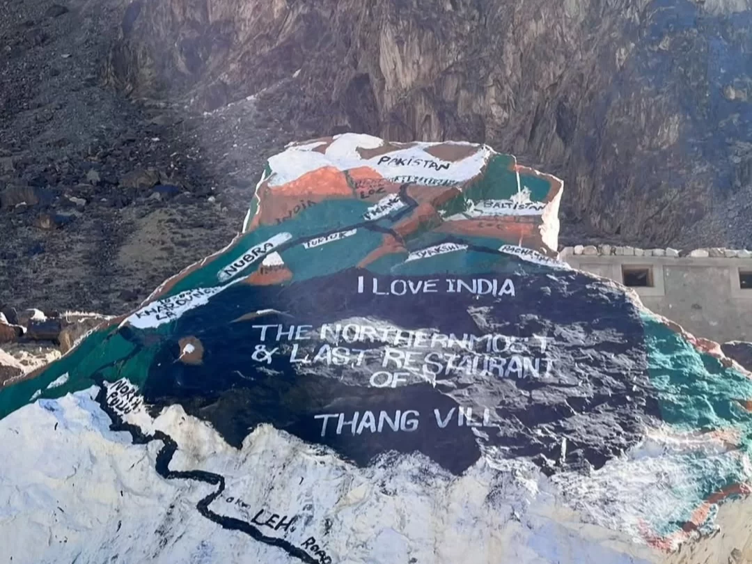 Patriotic rock sign at Thang Turtuk Ladakh proclaiming I Love India and the northernmost last village of India near Pakistan LOC with map painting and rugged Karakoram mountains, perfect patriotic border adventure with Ladakh tour package. 