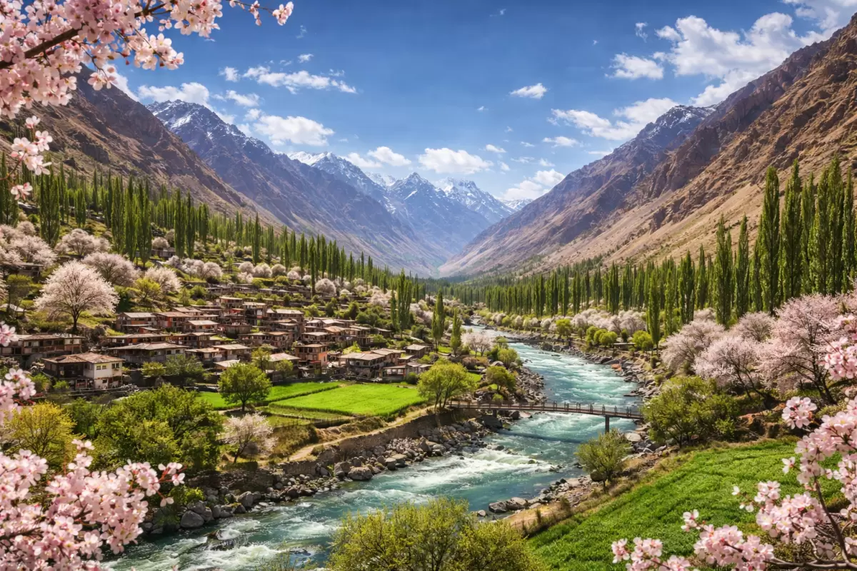 Stunning mountain valley landscape with turquoise river, blooming cherry blossoms, and traditional village nestled in the Himalayas