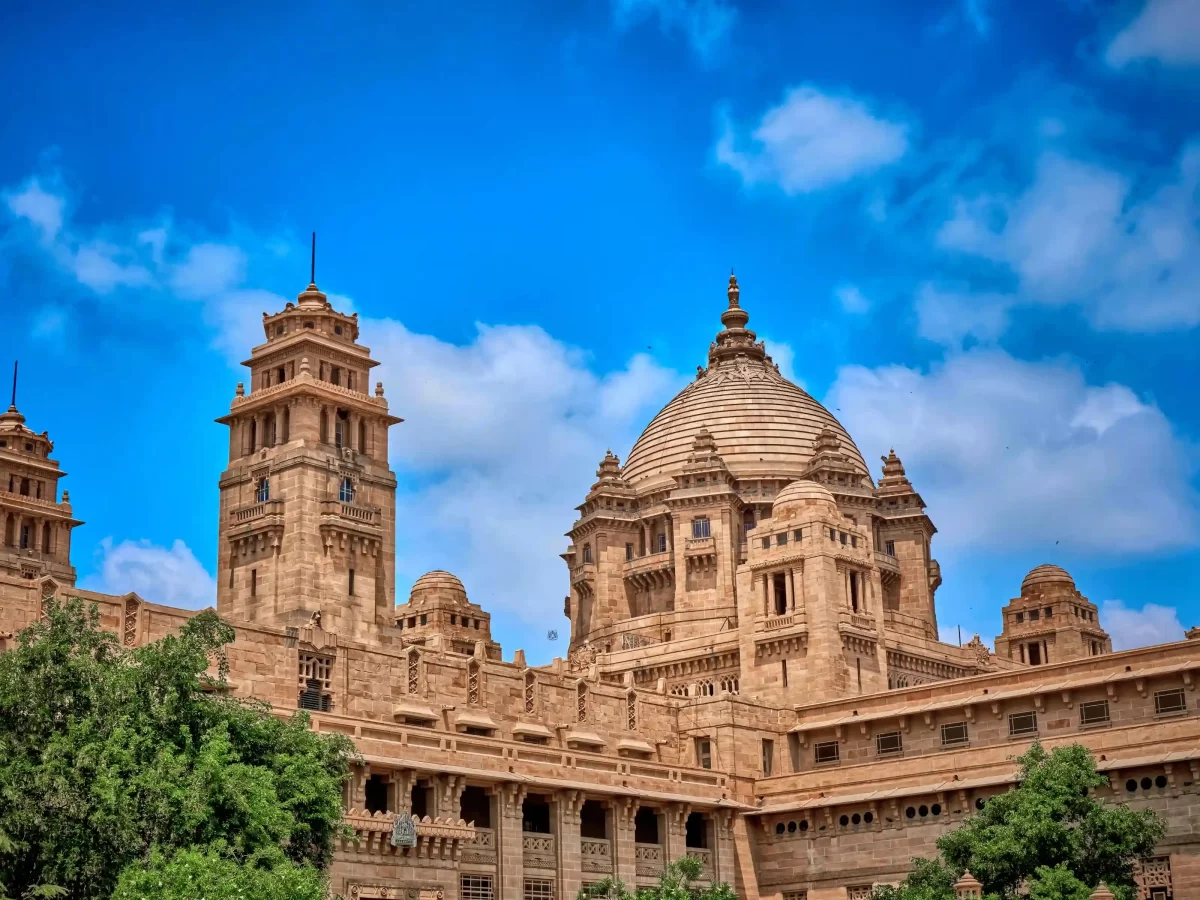 Umaid Bhawan Museum Jodhpur Art Deco-style sandstone gallery within the world's largest private residence, showcasing vintage automobiles, royal clocks, and personal artifacts of the Jodhpur royal family Rajasthan.