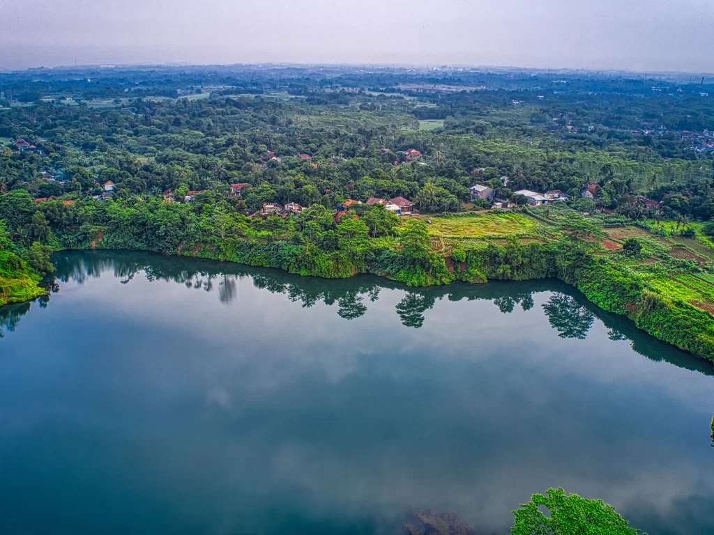 Valvan Lake View Point dawn aerial panorama serene lake surrounded lush tropical forests villages paddy fields misty horizon, perfect Lonavala Maharashtra nature tour packages. 