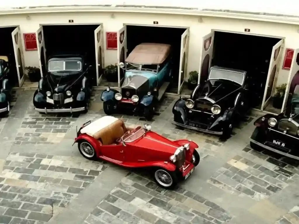 Vintage Car Museum Jaipur Stately 19th-century royal garage at the City Palace, showcasing a prestigious collection of classic Rolls-Royces, Cadillacs, and bespoke horse-drawn carriages Rajasthan.