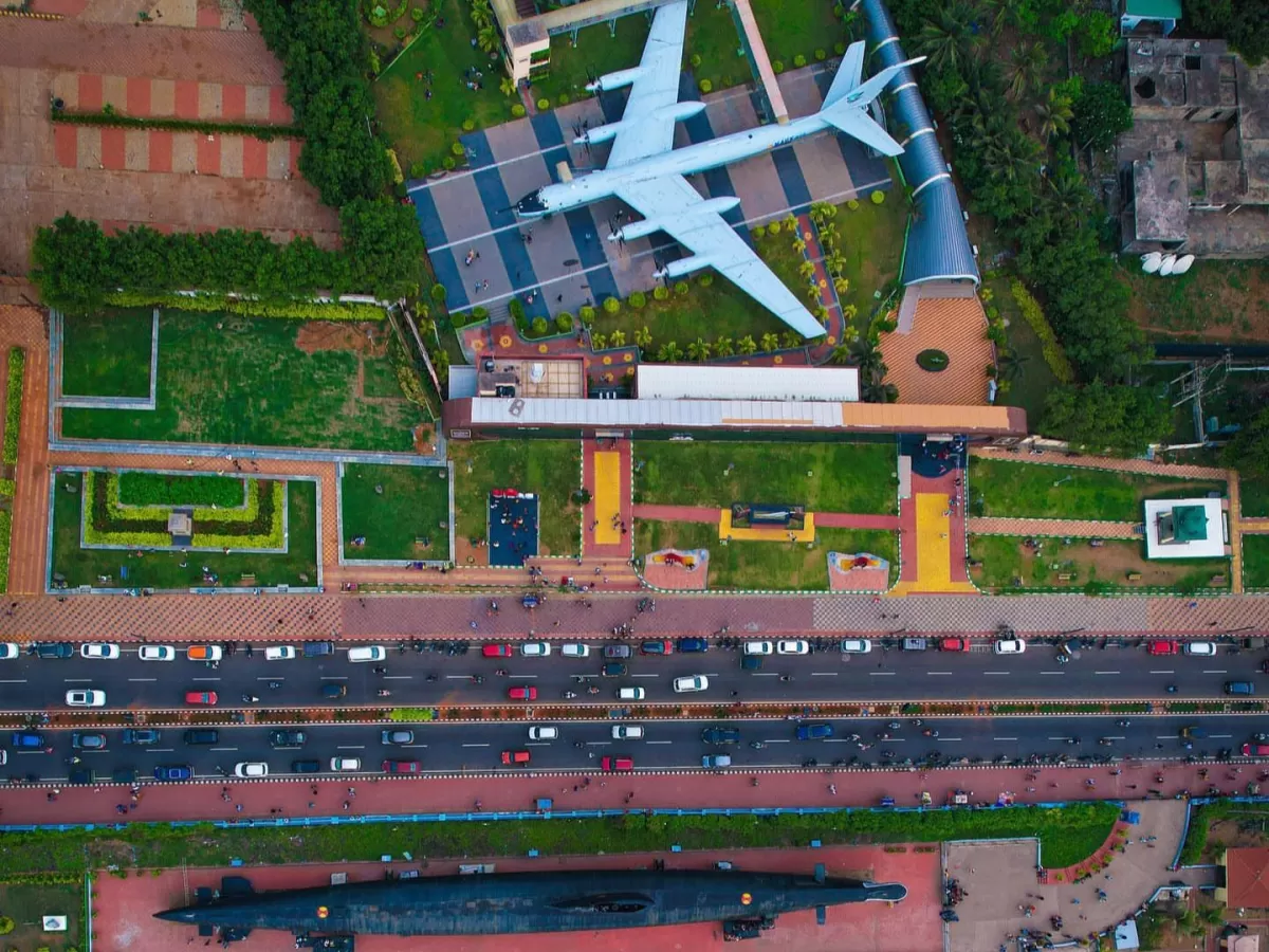 Aerial Tu-142 aircraft submarine INS Kursura Museum RK Beach Vizag, featuring greenery lawns road traffic, perfect naval Andhra Pradesh tour package.