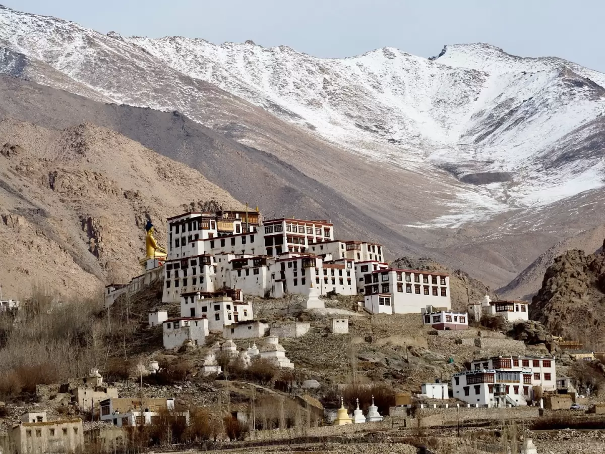 Alchi Gompa Ladakh monastery white buildings golden statue snowy mountains Indus Valley, perfect Leh Ladakh heritage trek Buddhist murals photography package. 