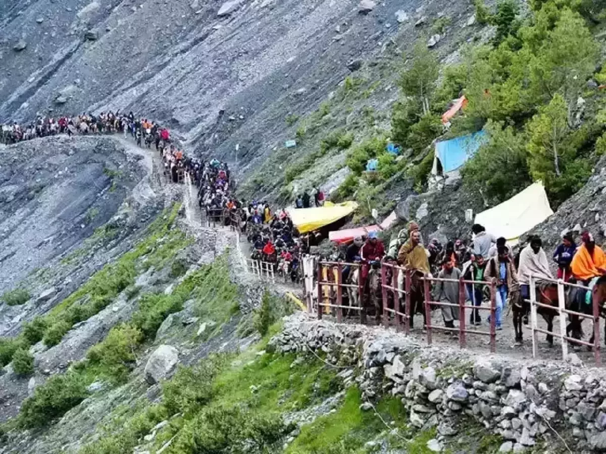 Amarnath Yatra pilgrims trekking steep mountain path, colorful tents ponies railings rocky snowy slopes langars, perfect Jammu Kashmir spiritual high altitude pilgrimage package. 