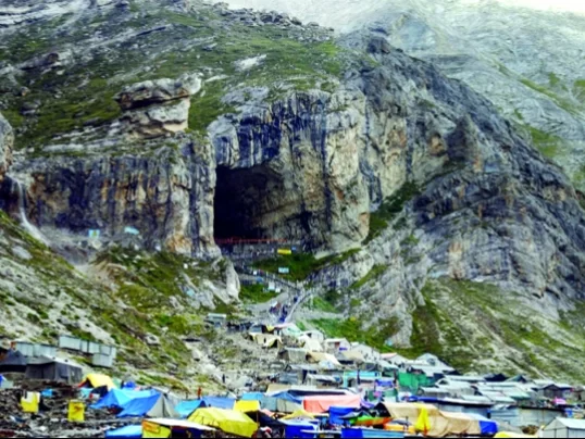 Amarnath Yatra cave shrine colorful tents pilgrims mountain backdrop, rocky entrance langars snowy slopes vibrant camps, perfect Jammu Kashmir spiritual ice lingam pilgrimage package.