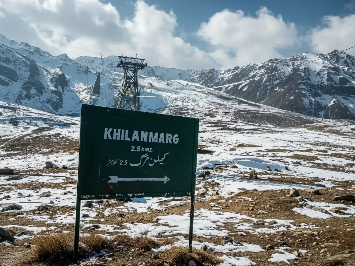 Gulmarg Kashmir Khelnmarg 2.5 km sign green board Urdu English snowy landscape gondola cable car tower Apharwat peaks blue skies clouds, perfect skiing gondola adventure tour package.