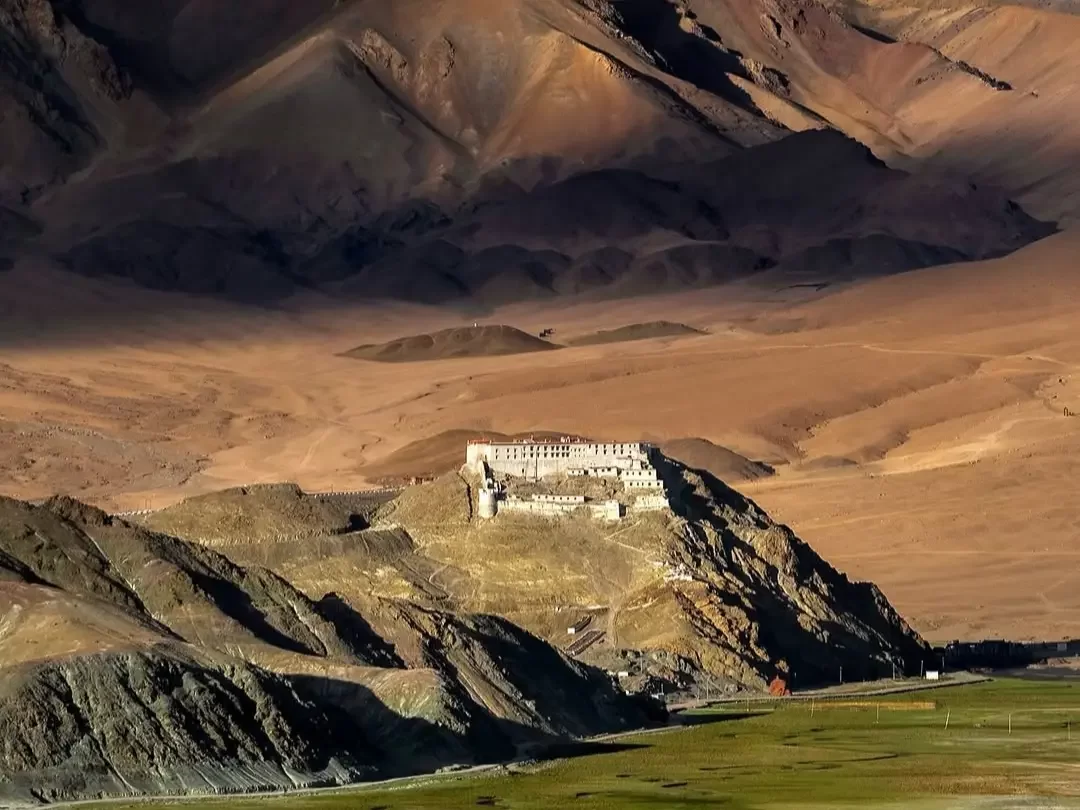 Hanle Monastery Ladakh golden hour fortress dramatic desert mountains rugged valley, 17th-century Drukpa Kagyu gompa cultural heritage, perfect observatory stargazing spiritual package.