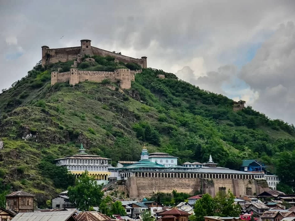Hari Parbat Fort hilltop with Takht Bhawani Temple Sharika Devi Shankaracharya Temple cloudy sky featured in Kashmir Srinagar tour packages