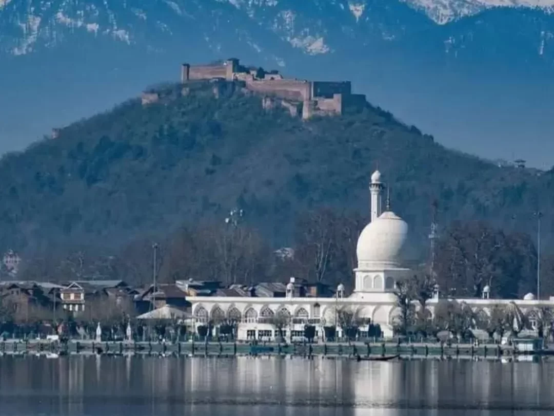 Hazratbal Shrine mosque foreground with Hari Parbat fort on hill Dal Lake Srinagar snowcapped Zabarwan mountains featured in Kashmir Srinagar tour packages