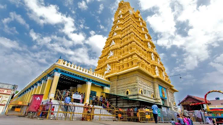 Shree Chamundeshwari Devi Temple in Mysuru during daylight, featuring golden gopuram and hilltop temple, perfect spiritual experience, Karnataka tour packages.