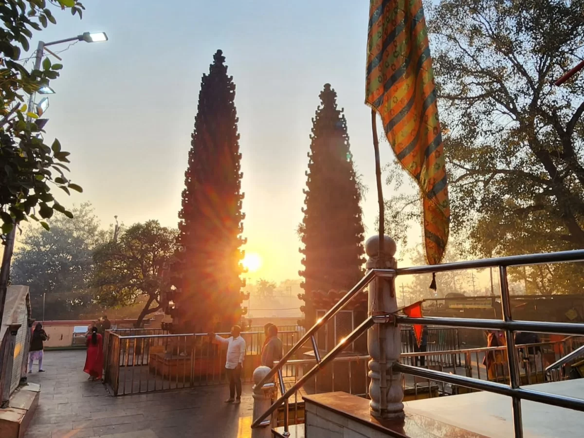 Harsiddhi Mata Temple deep stambha at Ujjain during sunrise, featuring twin pillars saffron flag devotees railing, perfect spiritual Madhya Pradesh tour package.