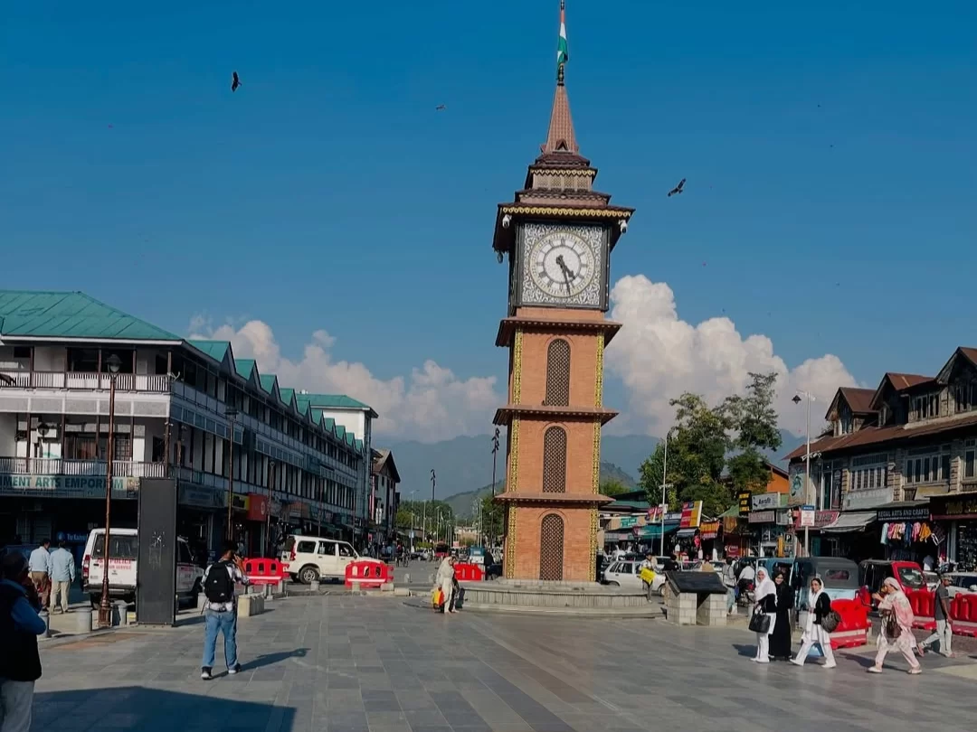 Clock tower Ghanta Ghar at Lal Chowk Srinagar market square with shoppers clear sky featured in Kashmir Srinagar tour packages