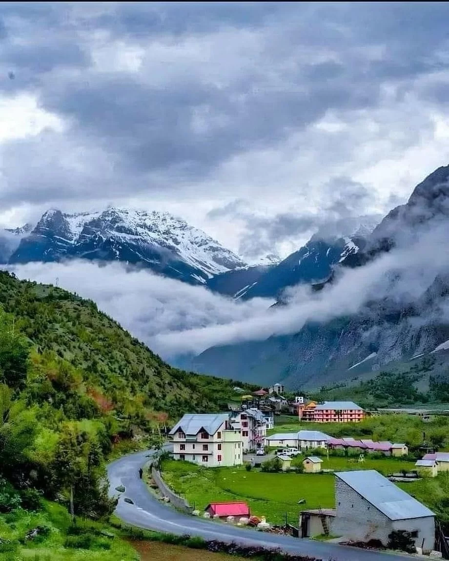 Scenic Jispa village in Himachal Pradesh with snow-capped mountains, lush valleys and winding road, a serene highlight in Himachal Pradesh tour packages