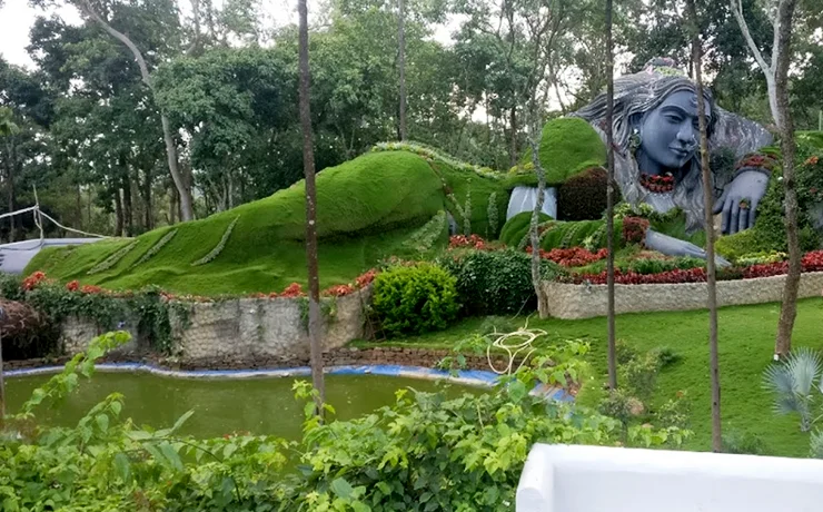 Mahatma Gandhi Park in Chikkamagaluru during daylight, featuring Shiva sculpture and lush gardens, perfect family experience, Karnataka tour packages.