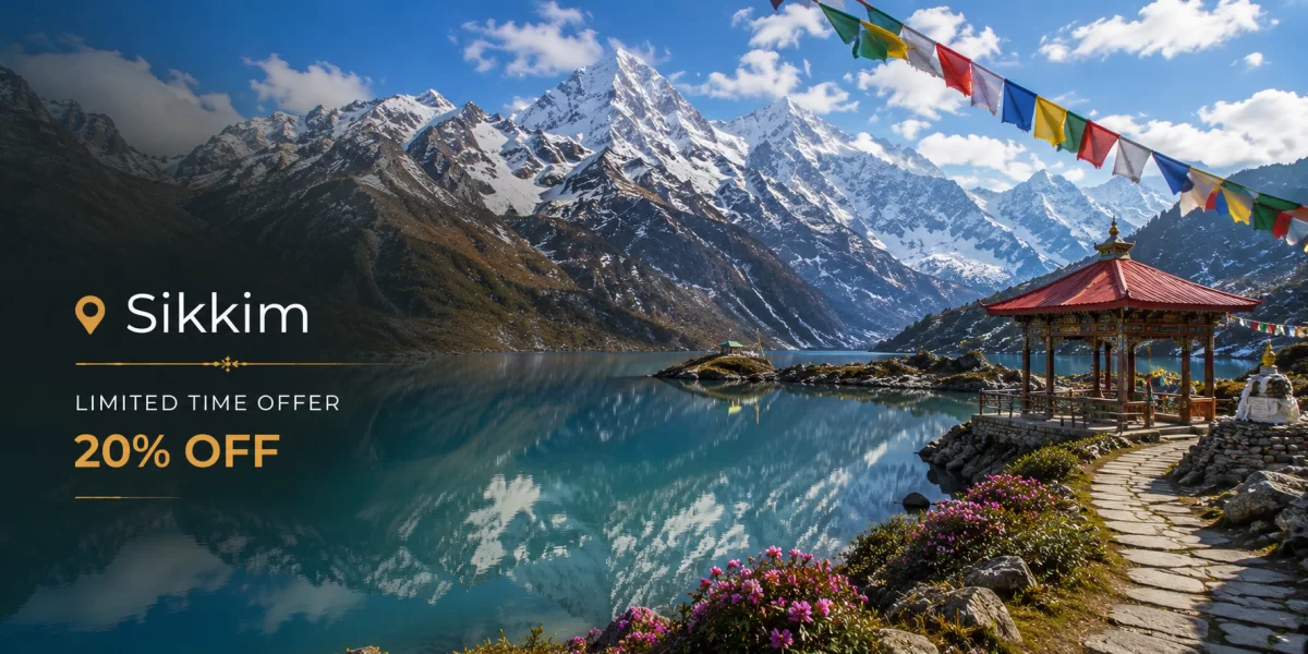 Sikkim mountain landscape featuring Gurudongmar Lake, snow-covered Himalayan peaks, colorful prayer flags, crystal-clear alpine lake, and serene high-altitude scenery.